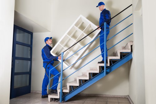 Removal team carrying furniture during a Winchmorehill flat move